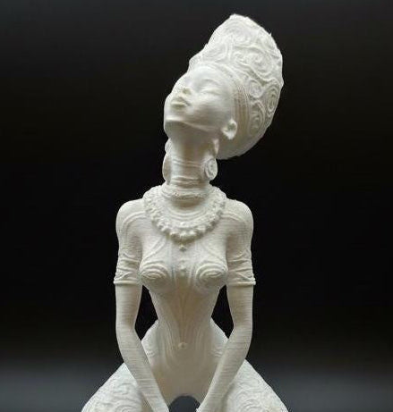 A unique, studio-exclusive Afrofuturist goddess statue in white with hand-applied gold mica highlights.
