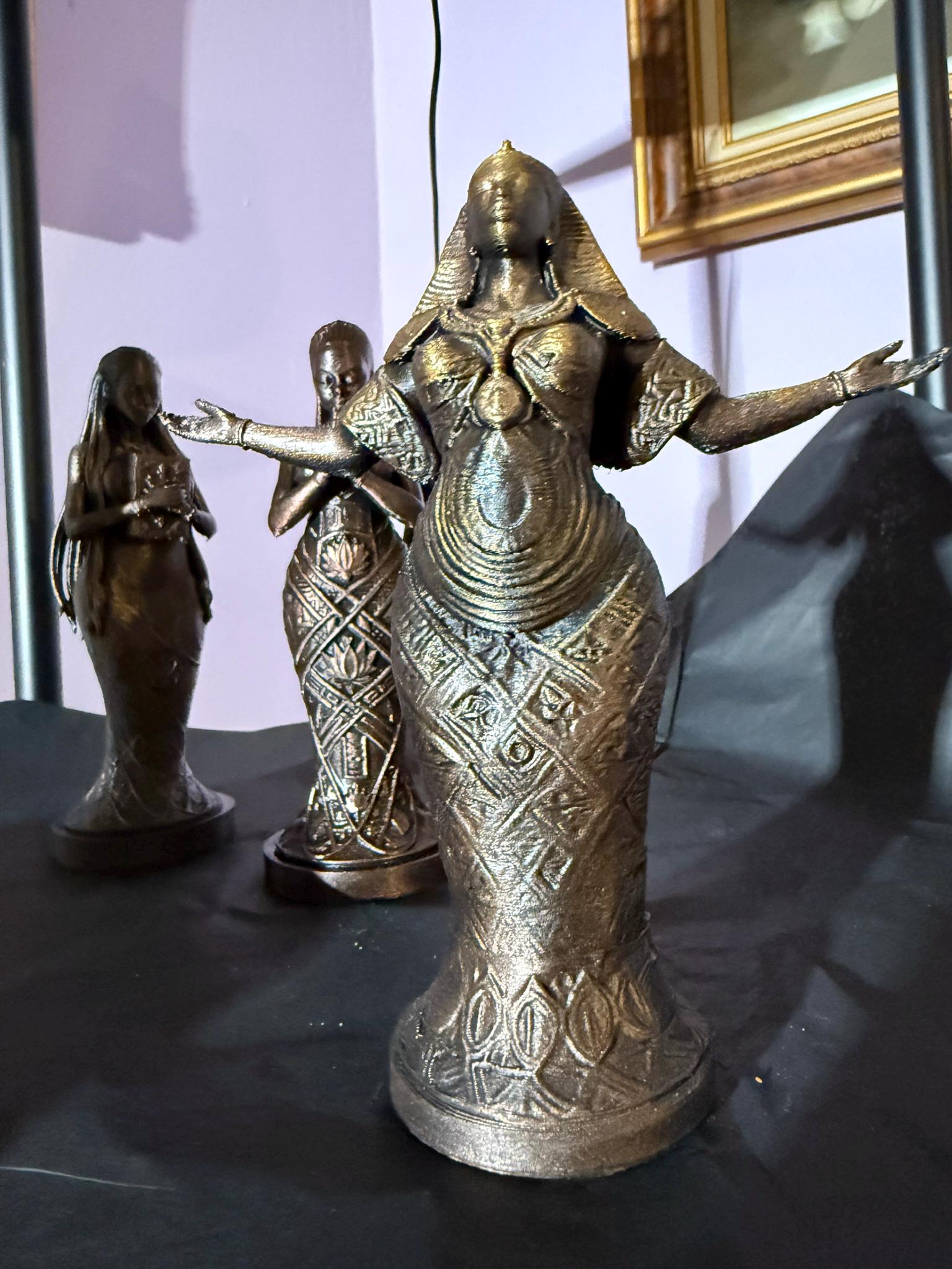 African woman Worship statue with praying hands in a faux bronze metallic patina on a dark background