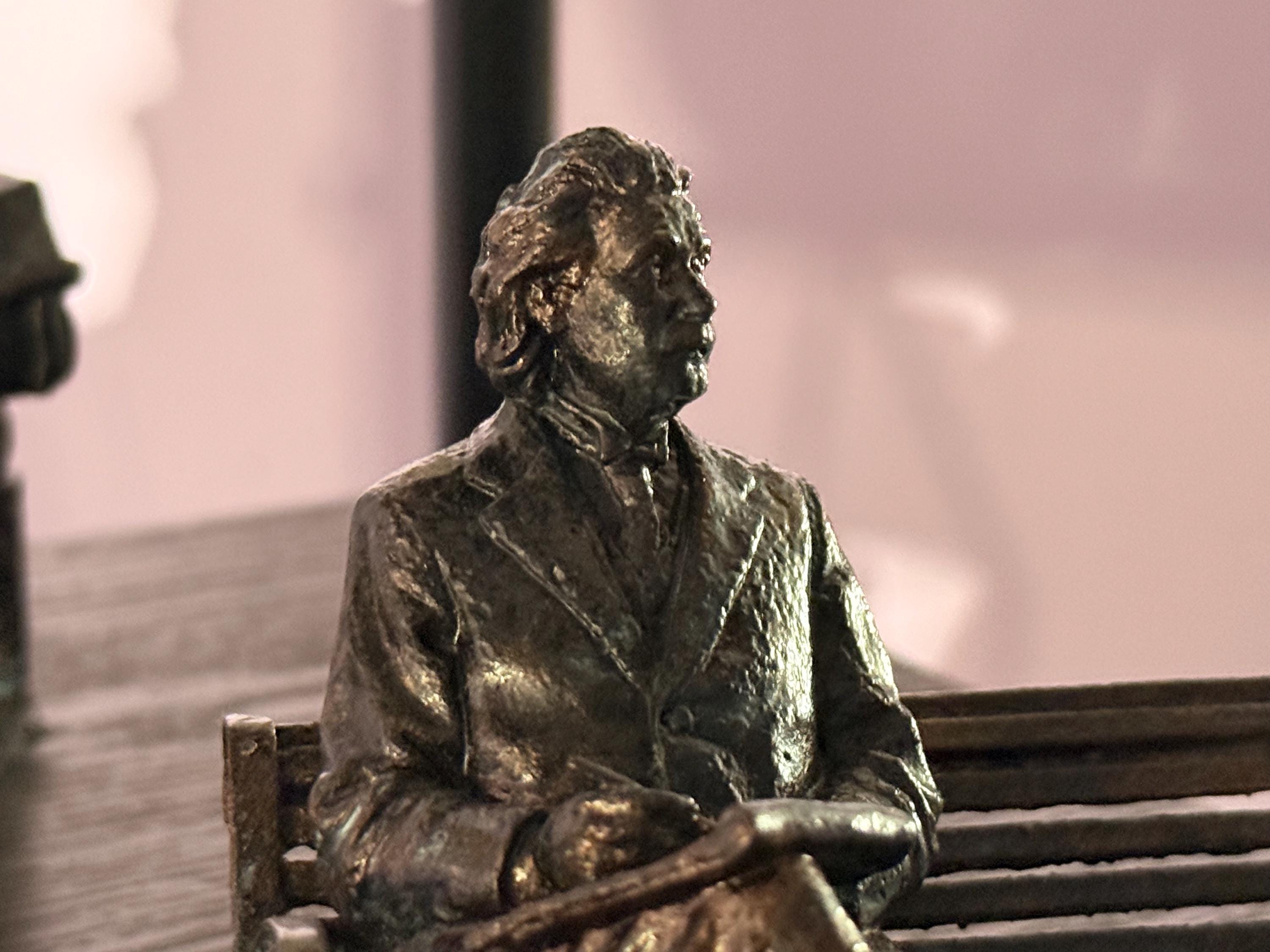 Albert Einstein on bench in bronze finish