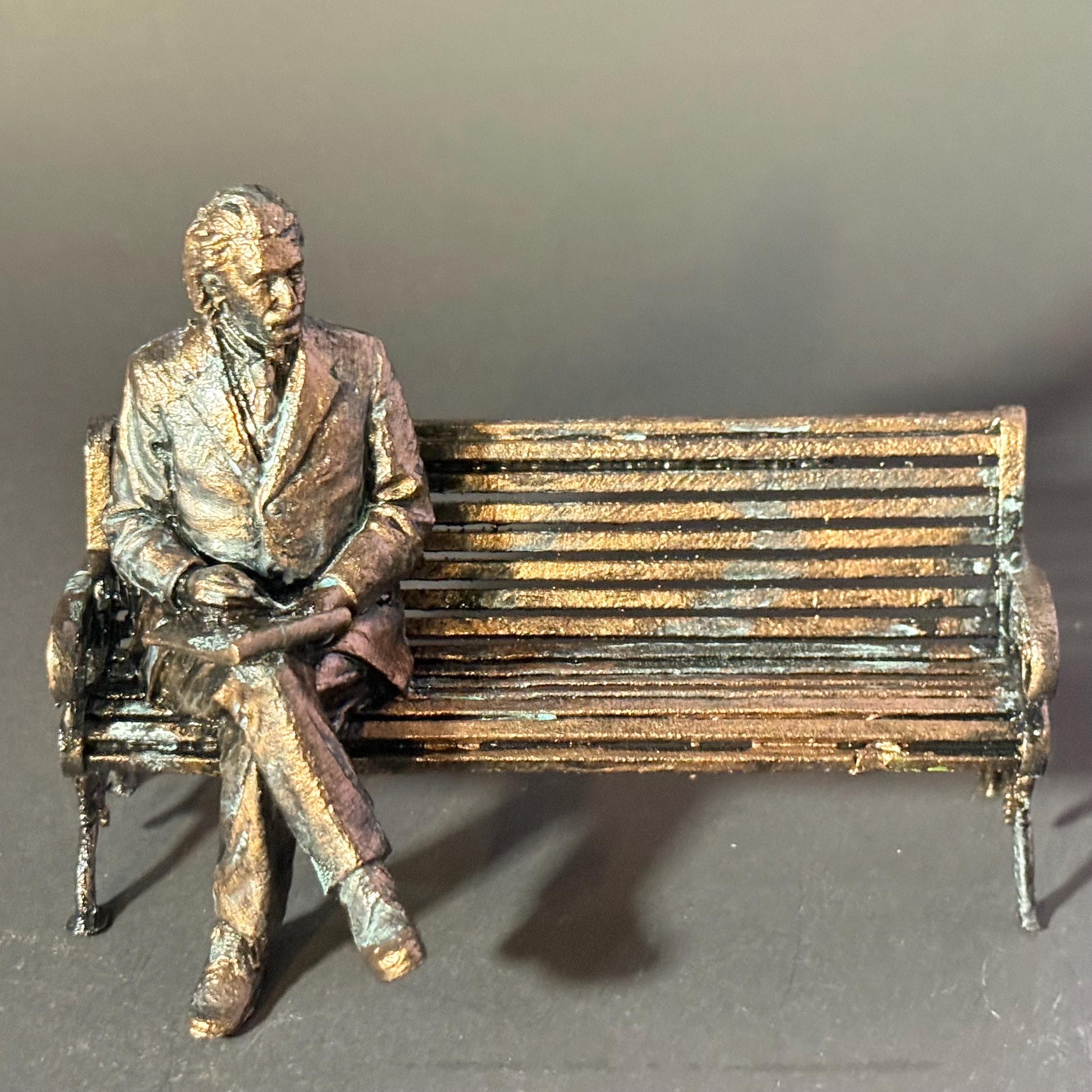 Albert Einstein on bench in bronze finish