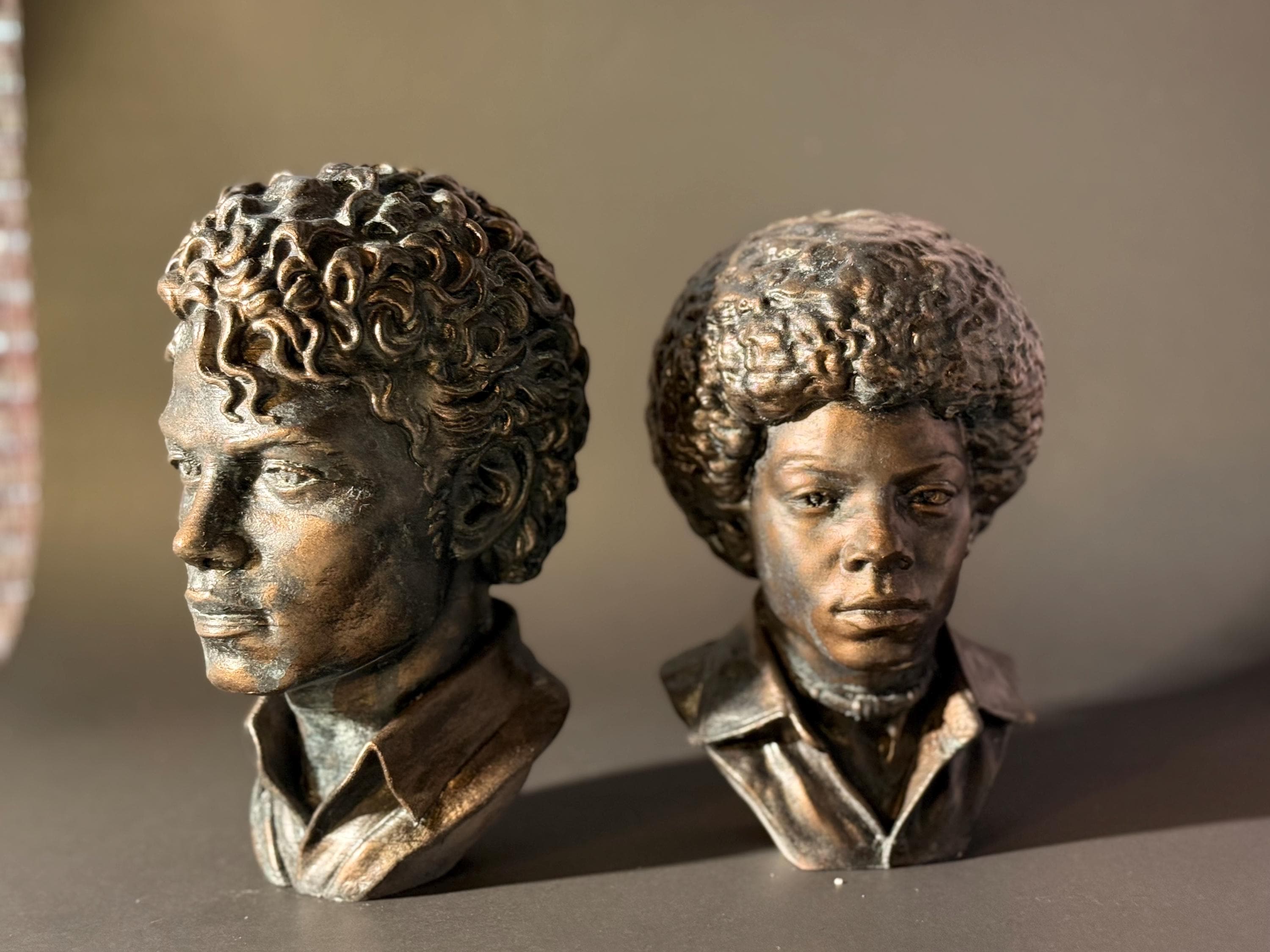 two bronze Michael Jackson at different ages